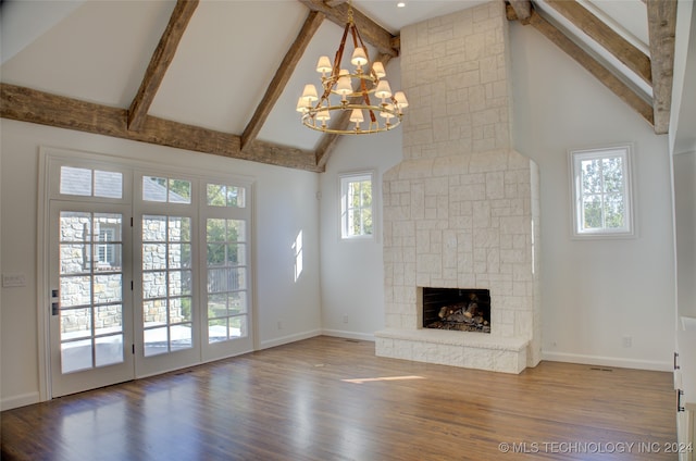 unfurnished living room featuring a healthy amount of sunlight and high vaulted ceiling