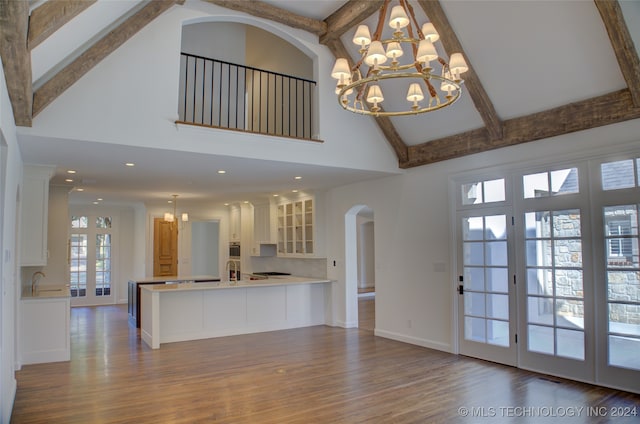 interior space with beamed ceiling, high vaulted ceiling, wood-type flooring, and sink