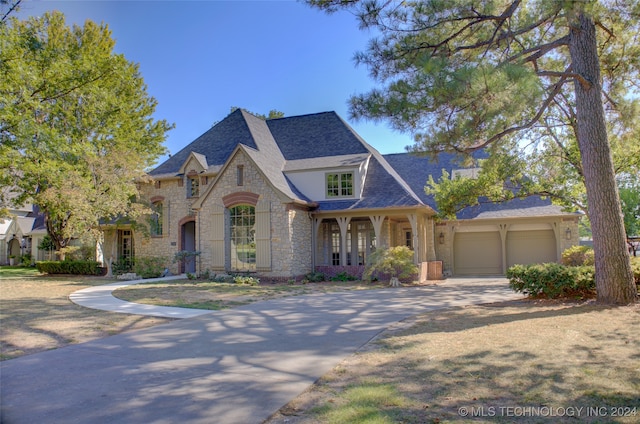 french provincial home with a garage