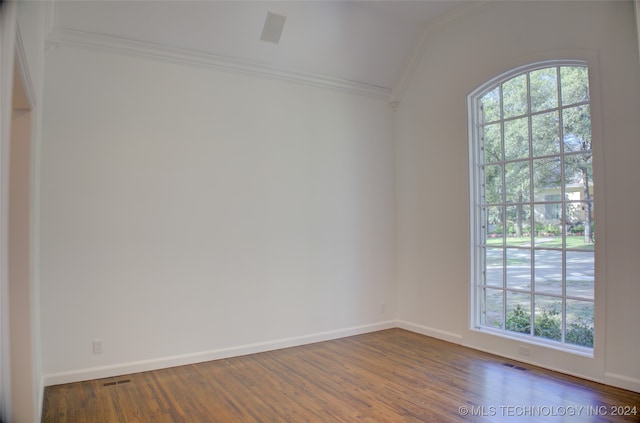 spare room with crown molding and dark hardwood / wood-style flooring