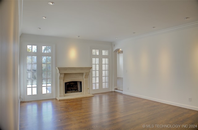 unfurnished living room featuring crown molding and hardwood / wood-style floors