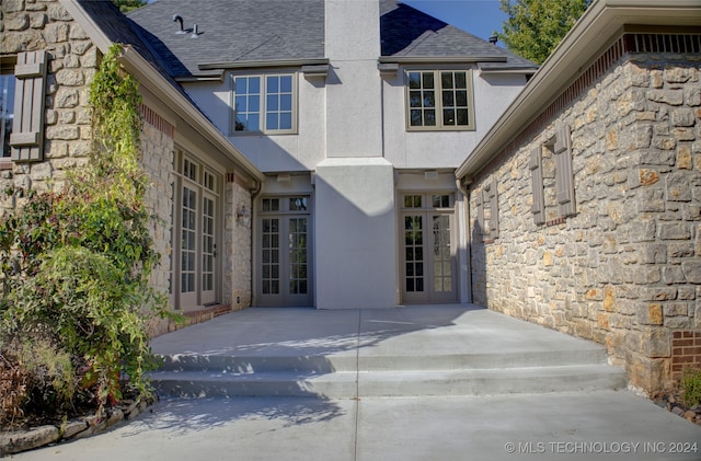 rear view of house featuring a patio area and french doors