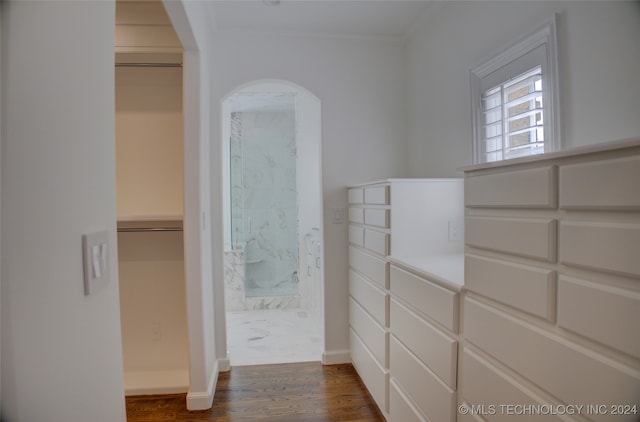 bathroom with ornamental molding, hardwood / wood-style floors, and walk in shower