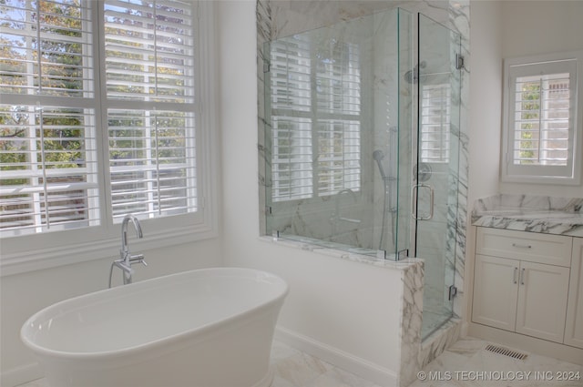 bathroom featuring vanity and shower with separate bathtub