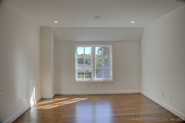 spare room featuring crown molding and dark hardwood / wood-style flooring