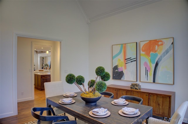 dining room featuring wood-type flooring and ornamental molding