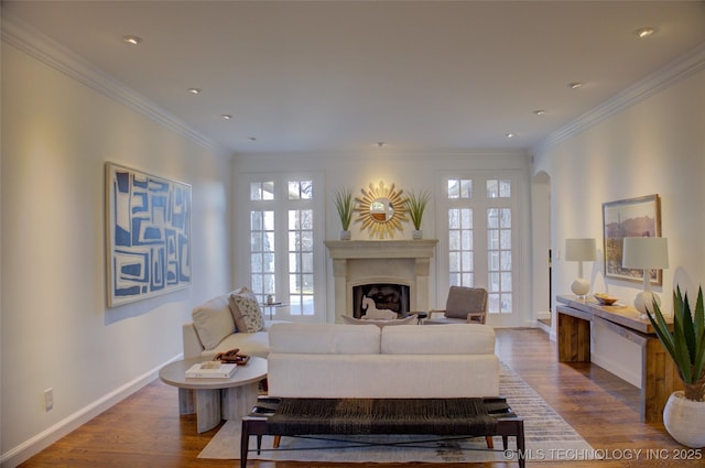 living room featuring crown molding, hardwood / wood-style flooring, and a healthy amount of sunlight