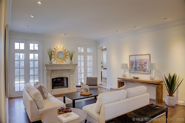 living room with crown molding, plenty of natural light, and dark hardwood / wood-style floors