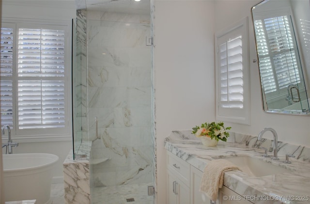 bathroom featuring vanity and shower with separate bathtub