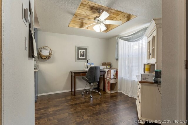 office featuring ceiling fan, dark hardwood / wood-style floors, and a raised ceiling