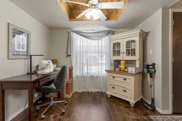 office featuring a textured ceiling, ceiling fan, a raised ceiling, and dark hardwood / wood-style flooring