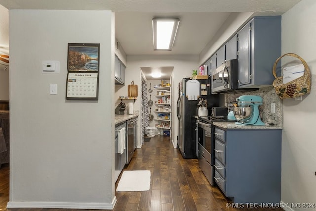 kitchen with stainless steel appliances and dark wood-type flooring