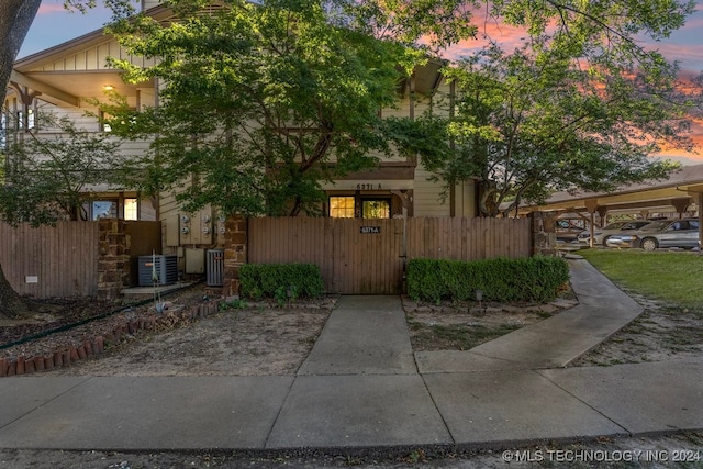 property exterior at dusk featuring central AC unit