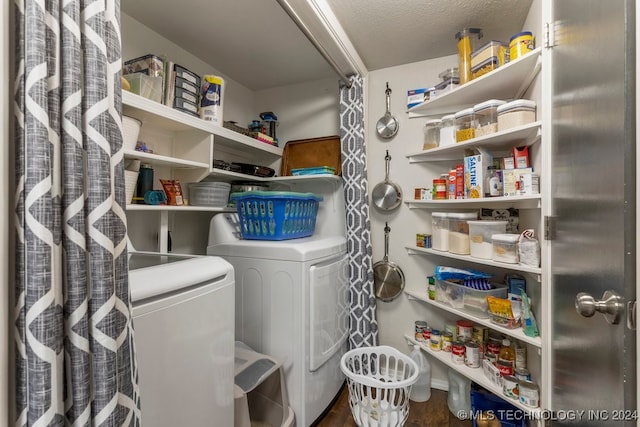 washroom featuring a textured ceiling and washer and clothes dryer