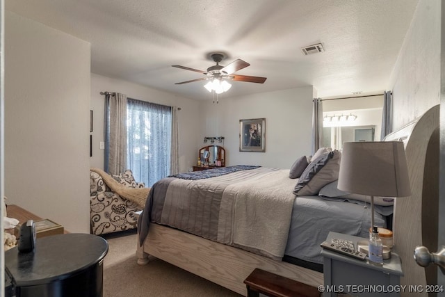 bedroom with carpet flooring, a textured ceiling, and ceiling fan