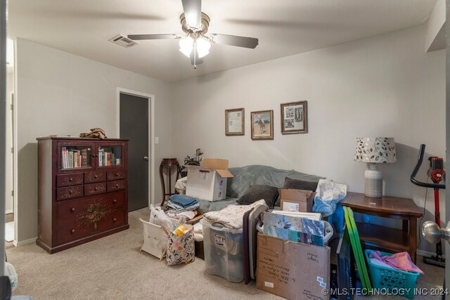 living area with ceiling fan and light colored carpet