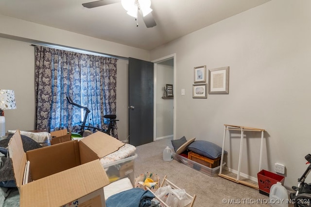 interior space with carpet floors and ceiling fan