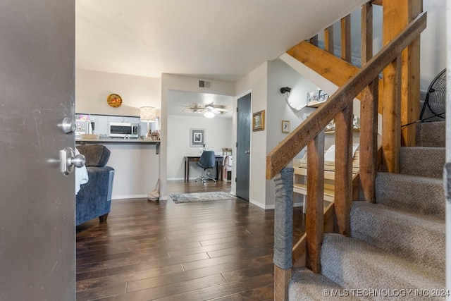 foyer entrance featuring ceiling fan and dark hardwood / wood-style flooring