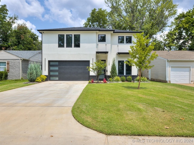 view of front of property with a front lawn and a garage