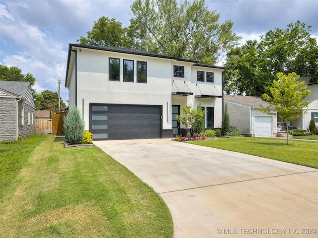 view of front of home featuring a garage and a front lawn