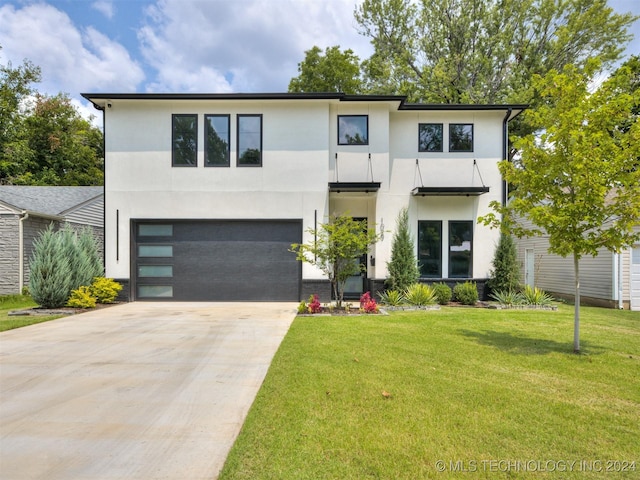 contemporary house featuring a front lawn and a garage