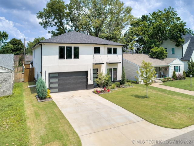 view of front facade featuring a front yard and a garage