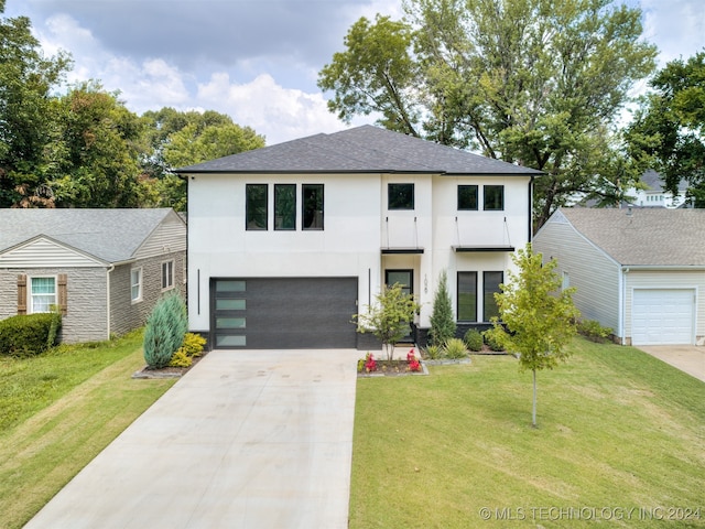 view of front of home featuring a front lawn and a garage