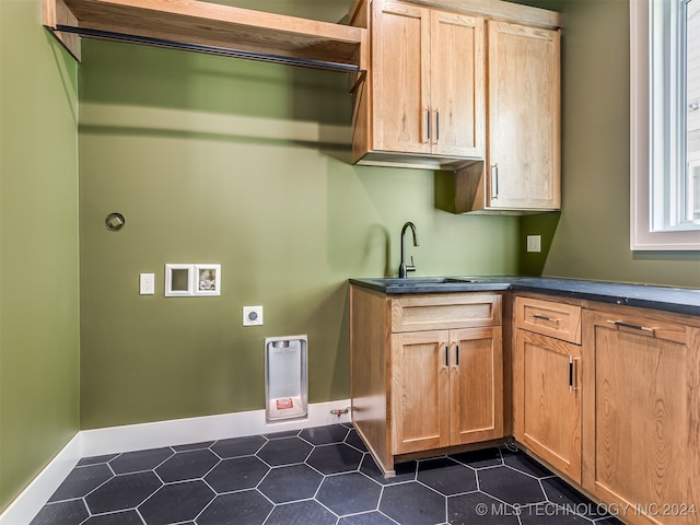 laundry area with hookup for an electric dryer, cabinets, sink, and hookup for a washing machine