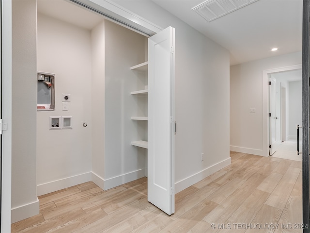 washroom featuring hookup for an electric dryer, washer hookup, and light hardwood / wood-style flooring