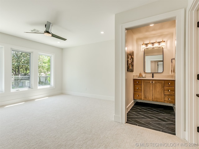 interior space with ceiling fan and vanity