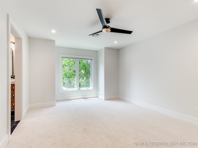 empty room with ceiling fan and light colored carpet