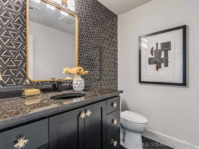 bathroom featuring tile patterned floors, vanity, and toilet