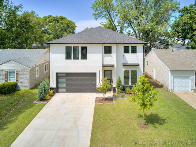 view of front of house with a front yard and a garage