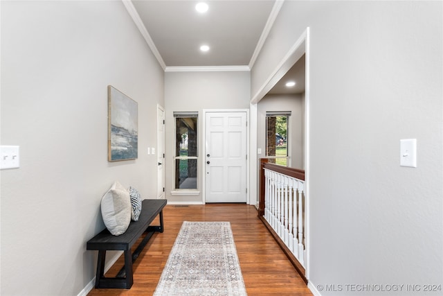 entrance foyer with hardwood / wood-style floors and crown molding