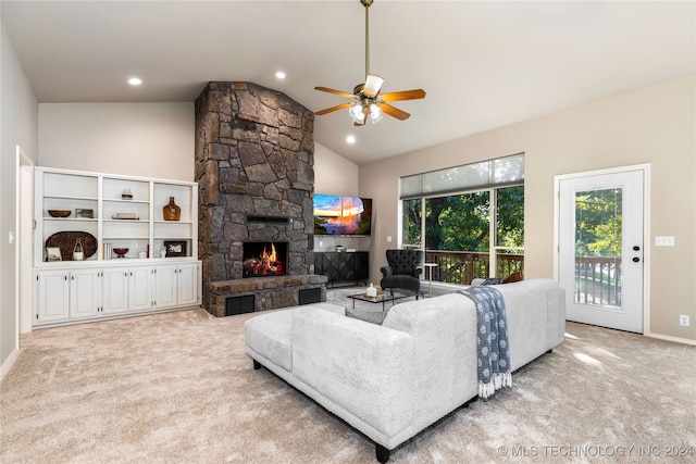 living room with lofted ceiling, light carpet, a stone fireplace, and ceiling fan