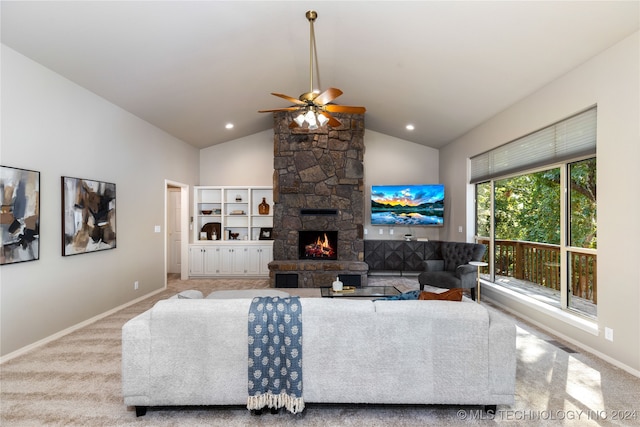 living room with a stone fireplace, vaulted ceiling, light carpet, and ceiling fan