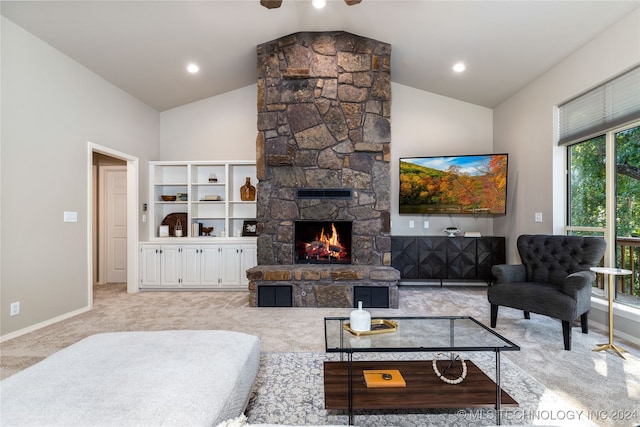 carpeted living room featuring vaulted ceiling, a fireplace, and ceiling fan