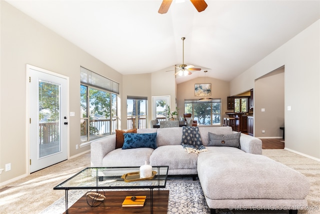 living room featuring light carpet, vaulted ceiling, and ceiling fan