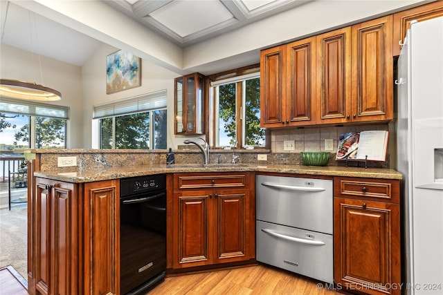 kitchen featuring sink, light wood-type flooring, stone countertops, stainless steel dishwasher, and white fridge