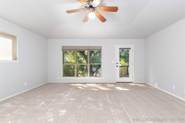 carpeted empty room with ceiling fan and lofted ceiling