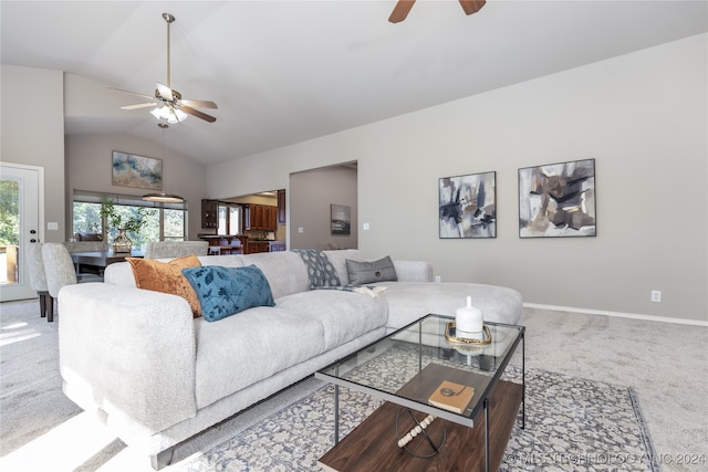 carpeted living room featuring ceiling fan and vaulted ceiling