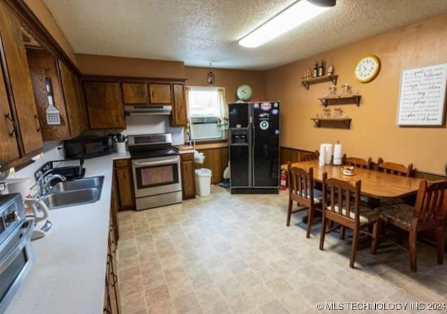 kitchen with a textured ceiling, sink, and black appliances