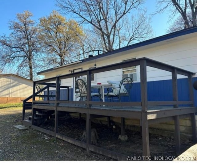 rear view of property with a wooden deck