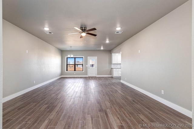 unfurnished living room with ceiling fan and dark hardwood / wood-style flooring