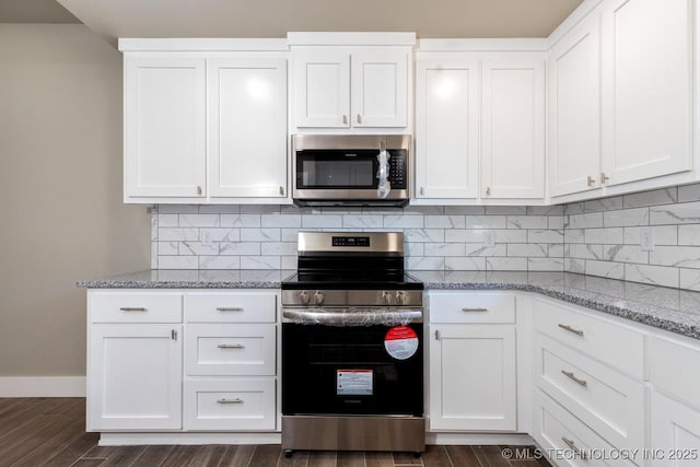 kitchen featuring tasteful backsplash, white cabinets, light stone counters, stainless steel appliances, and dark wood-type flooring