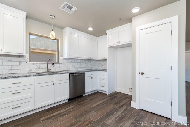 kitchen featuring pendant lighting, sink, dishwasher, white cabinets, and decorative backsplash