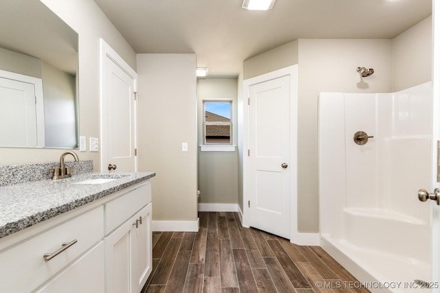 bathroom with a shower and vanity