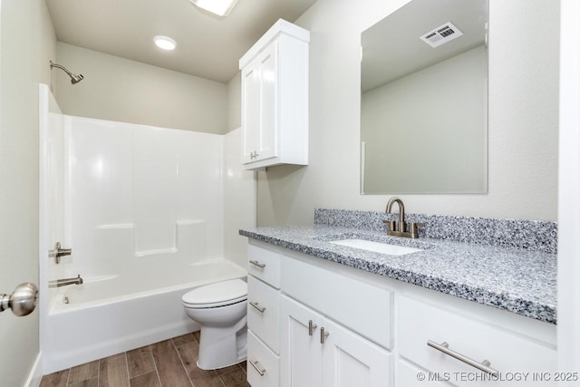 full bathroom featuring shower / tub combination, vanity, and toilet