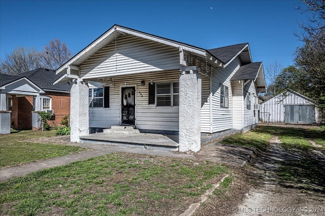 bungalow-style house with a front lawn