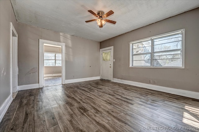 unfurnished room featuring ceiling fan and dark hardwood / wood-style flooring